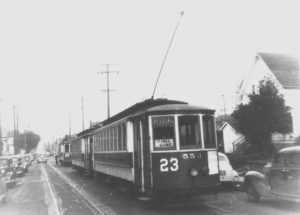 Line of three street cars headed to Vaughn Street Ballpark. Signs in the front street car #23 Special "TO BALL GAME"-there are some sweet vintage 1940s looking cars parked on the street. The purpose of this image is to highlight that streetcars were a big deal in Slabtown.