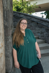 Tanya March leaning up against the Steps of St. Patricks Church. View of basalt wall and steps.