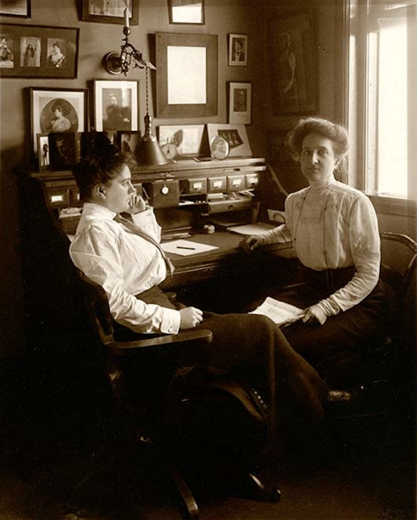 Two women at a desk.