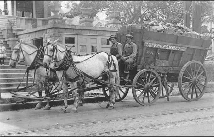 Image of two horses pulling a rented wagon load of Slabwood in Portland Oregon