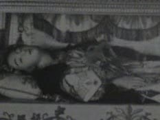 Life size wax doll of a christian Saint. She looks asleep she is resting under the alter.