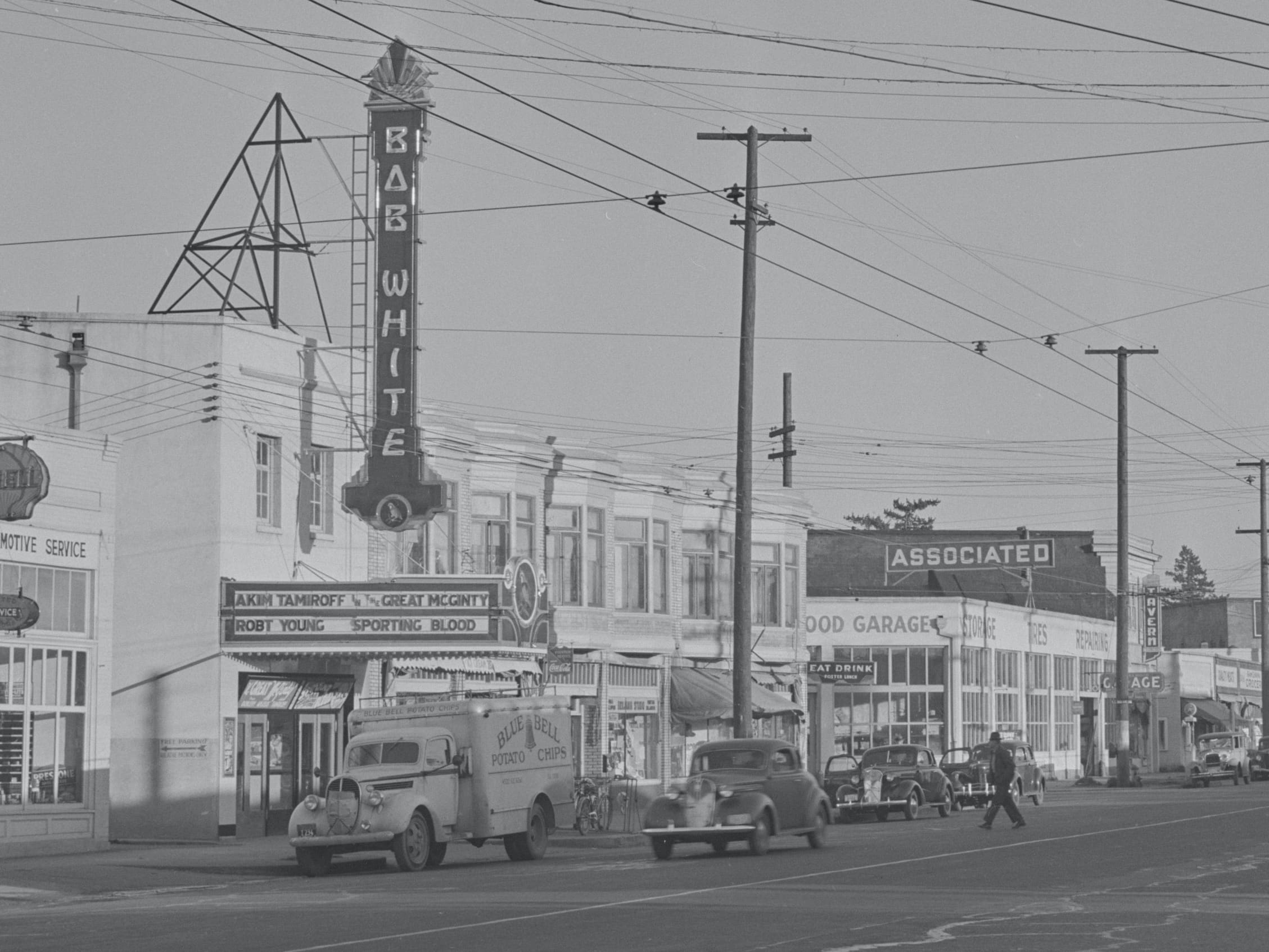 The Bob White had a small foot print on Foster and a large marquee and neon sign to capture the focus of drivers cars in the image look like 1940s vintage