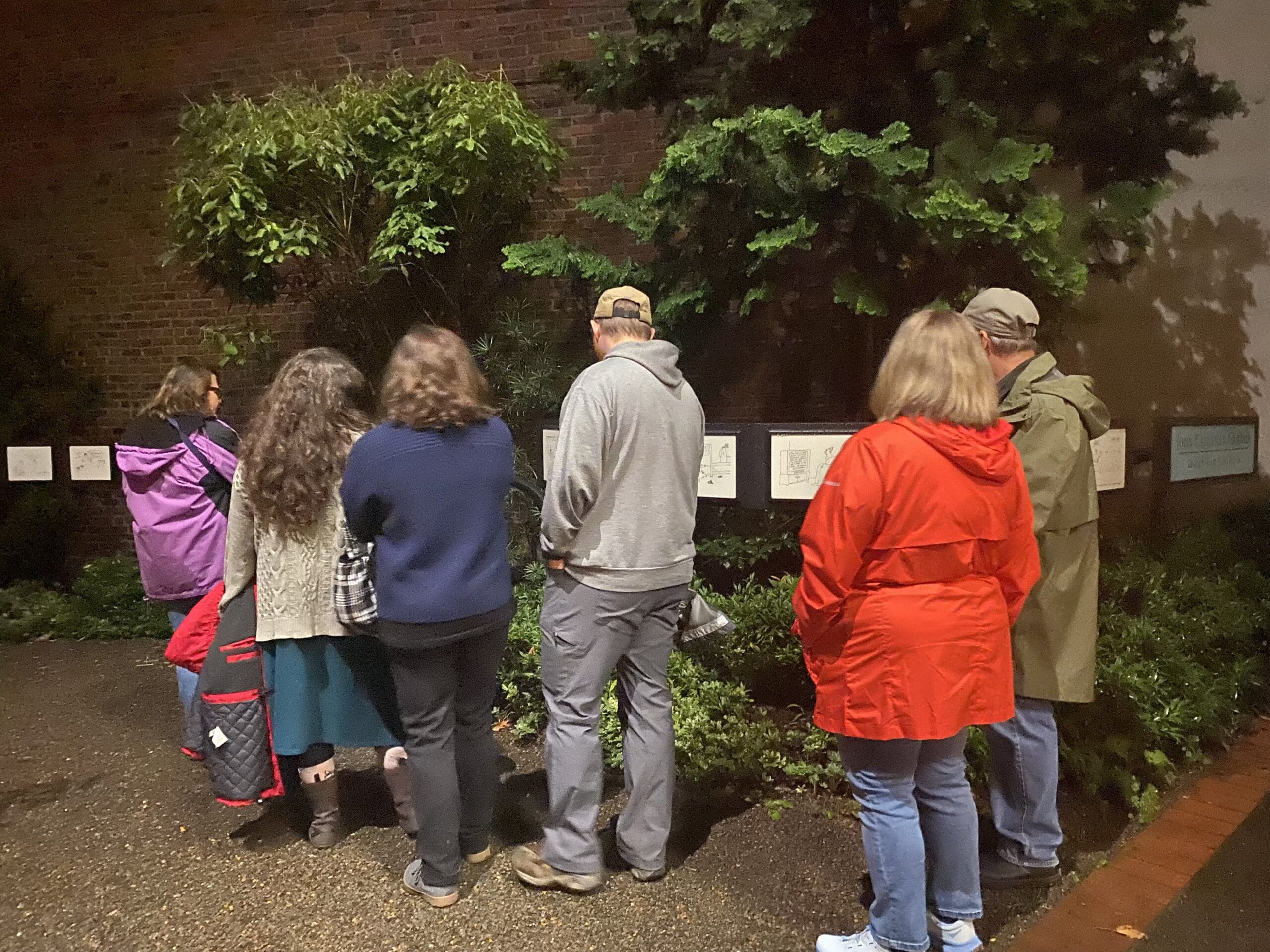 Six guests reading John Callahan Cartoons. It is a series of markers with the cartoons drawn by a Quadriplegic.