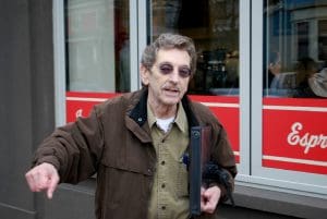 Mike Ryerson Binder of historic images in hand. Wearing sun glasses, white male around 70 years of age.