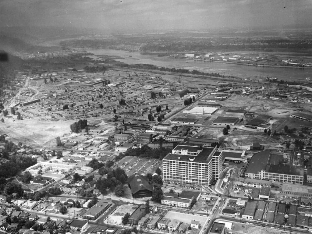 Aerial photo of Guild's Lake Courts c. 1944 looking east the oil tanks in the CEI hub Willamette river to the top (north) you see what in Montgomery park today once Wards Dept. Store black and white picture, the Guilds lake housing shiwing is not the fourplexes we associate with war housing they are little single and duplex units at the time these hiher quality electric units were used to tempt folks to move to Portland in 1942