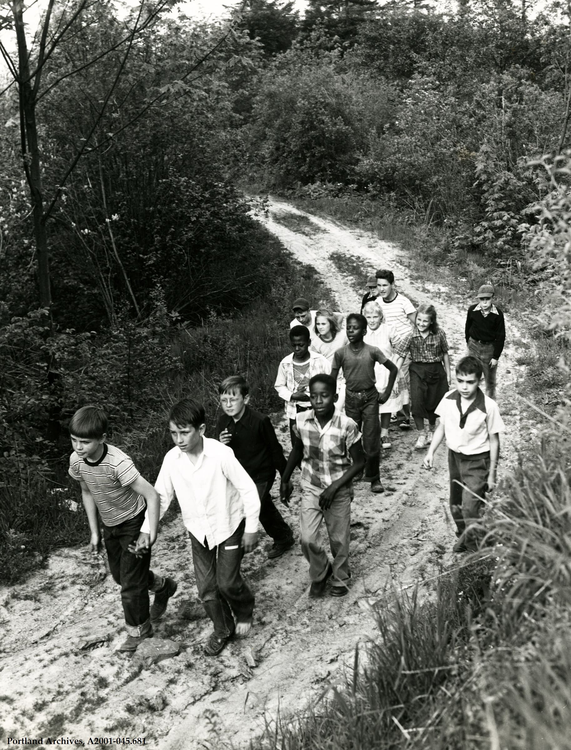 Mixed Race Group of about a dozen children approx. ages 10 on a dirt trail